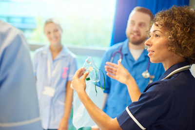 Medical professionals discussing care techniques or equipment.