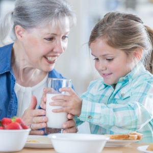 Grandaughter and grandmother having breakfast
