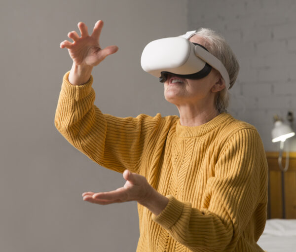 virtual reality. VR, future, gadgets. senior woman playing game in virtual reality glasses and holds joysticks at home